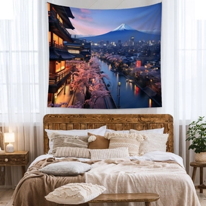 Cozy bedroom setting featuring a Mount Fuji and cherry blossom tapestry wall hanging
