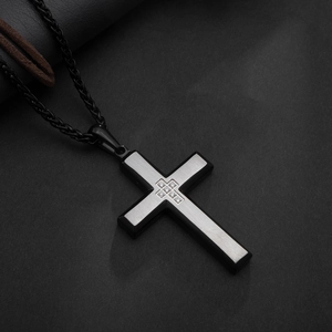 Polished black and silver stainless steel cross pendant with crystals on a woven cord