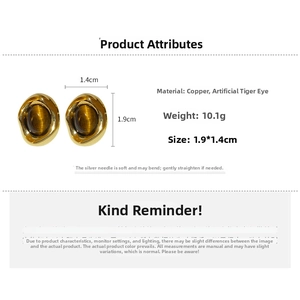 Macro shot of vintage gold-plated stud earrings featuring oval imitation tiger eye stones