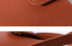 Macro shot of brown leather texture and precision stitching on this mini crossbody bag