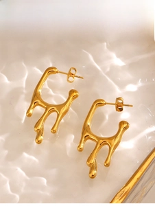 Macro shot of gold-plated fluid lava stud earrings with glossy mirror finish