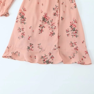 Pink floral V-neck chiffon dress featuring a tiered ruffle hem and delicate blossom print