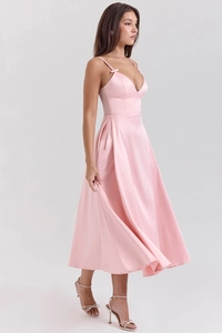 Detail of pink satin V-neck dress showing delicate bow straps and glossy fabric texture