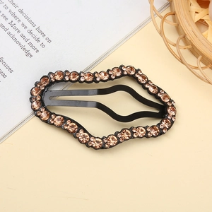 Close-up of a black wavy alloy BB hair clip featuring sparkling champagne rhinestones