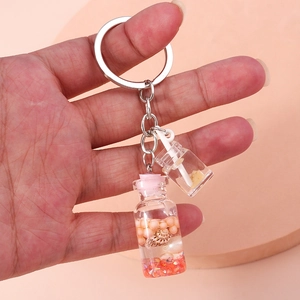 Detail of wish bottle keychain with shells, pearls and mini drink cup charm