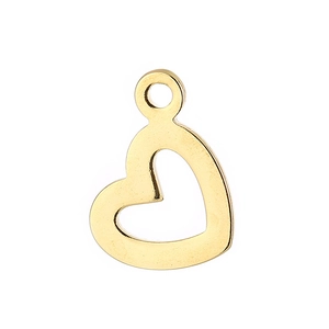 Macro shot of a hollow heart-shaped gold-plated pendant with a polished metal finish