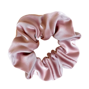 Pink satin scrunchie with silky finish for women, minimalist hair accessory on white background