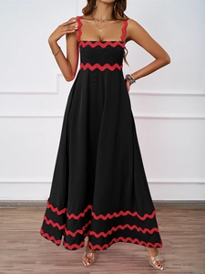 Detail of red wavy stripe patterns on a long black sleeveless summer dress for women