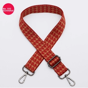 Detail of No. 332 geometric red and orange woven bag strap with gunmetal metal hardware