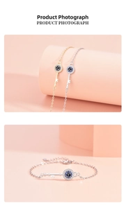 Detailed view of gold and silver key bracelets with zircon evil eye charms on pink props