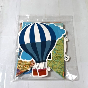 Travel theme party banner with hot air balloons and world maps in clear packaging