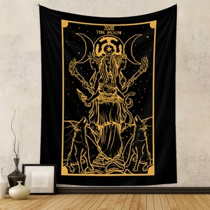 Detail of The Moon tarot tapestry with gold sun and moon motifs on a black backdrop