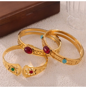 Detail of vintage gold plated titanium steel bracelets with colorful inlaid natural stones