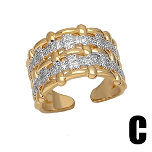 Two-tone gold and silver wide woven ring with sparkling cubic zirconia in open design