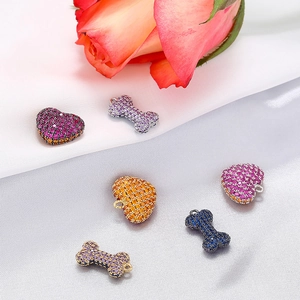 Set of 6 luxury heart and bone pendants with colorful rhinestones on silk background