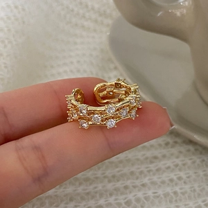 Close-up of triple-layered gold open ring with sparkling cubic zirconia on a hand