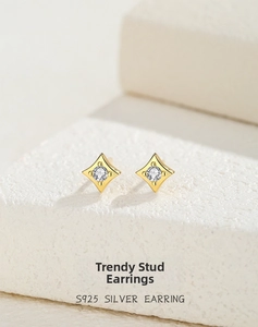 Detailed shot of S925 silver star stud earrings with white zircon on stone background