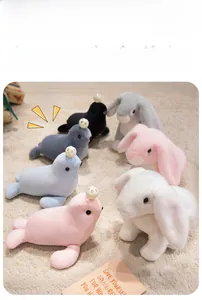 Selection of soft plush seal and rabbit toys in assorted pastel colors on a cozy rug