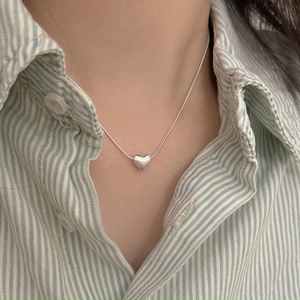 Minimalist 925 sterling silver heart necklace with sleek snake chain worn on neck