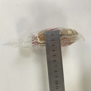 Detail of fabric gingerbread man ornament showing 11cm measurement on a metal ruler