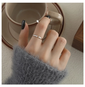 Close-up of a silver cat paw ring with sparkling diamonds on a woman's hand