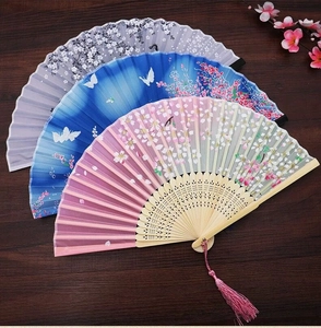 Detail of three silk folding fans with cherry blossom patterns and elegant tassels