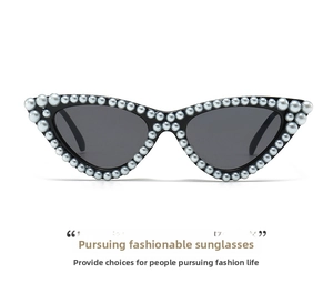Detailed view of retro black cat-eye sunglasses with white faux pearl embellishments