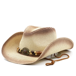 Detail of woven straw cowboy hat with gradient finish and ethnic bead decoration strap