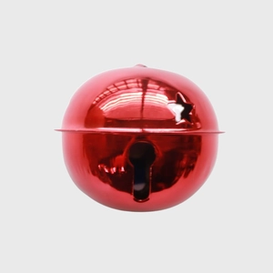Detail of red metal Christmas bell featuring star cutouts and festive glossy finish