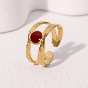 Minimalist gold plated stainless steel open ring with irregular texture and red accent