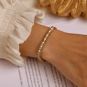 Detailed shot of a gold tennis bracelet with white cubic zirconia on a wrist