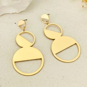 Exaggerated golden geometric drop earrings with hollow semicircles on stone surface