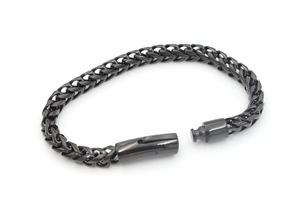 Close-up of black titanium steel Cuban chain bracelet with secure press buckle