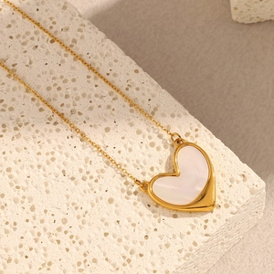 Macro shot of 18K gold plated heart pendant necklace with white shell inlay details