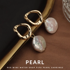 Vintage Baroque natural freshwater pearl earrings with irregular gold hoops on silk fabric