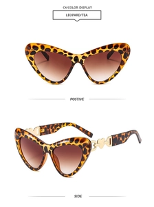 Detail view of leopard cat-eye sunglasses featuring golden heart-shaped hollow temple decor