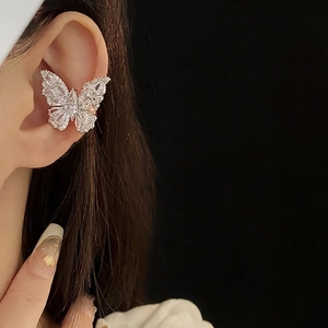 Elegant zircon butterfly ear cuff earring on female model with minimalist metal design