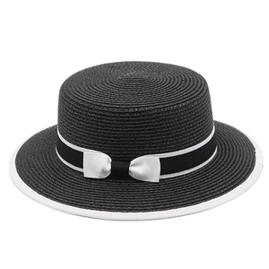 Black boater straw hat with white ribbon bow and wide brim for sun protection