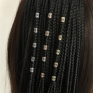 Ethnic style hollow metal braid rings in gold and silver finish on black braided hair