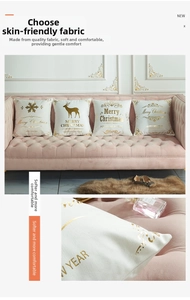 Detail of Christmas pillow cover with golden elk and snowflake foil prints on soft white fabric