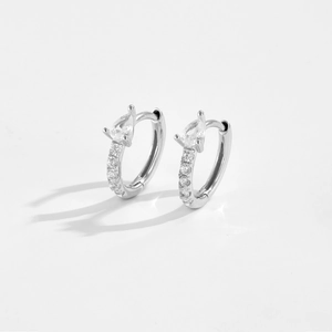 Close-up of S925 silver hoop earrings with pear-cut cubic zirconia in a polished finish