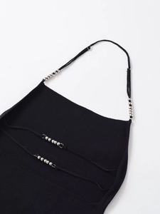 Close-up of black knitted halter top with metallic silver beads on thin shoulder straps