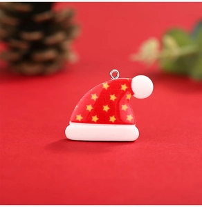 Close-up of a red and white resin Christmas hat pendant with a yellow star and metal ring