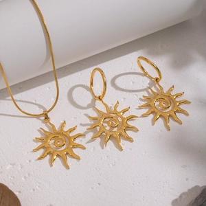 Golden stainless steel jewelry set featuring sun spiral pendant necklace and matching earrings