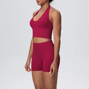 Detail view of seamless ribbed knit fabric on a magenta halter bra and high-waist shorts set