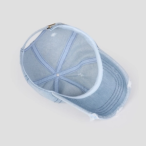 Detail view of the interior construction and reinforced tape of the ripped denim baseball cap