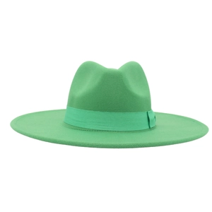 Detail of the bright green wool fedora hat featuring a matching wide ribbon and wide brim