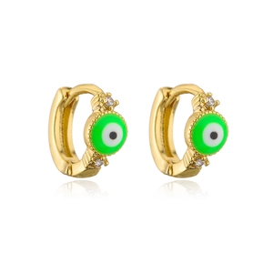 Detail of gold 18K plated evil eye earrings with green enamel and white zircon stones