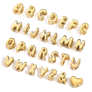 Detailed view of the full set of gold bubble capital letters, ampersand, and heart beads.
