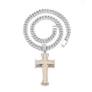 Détail macro du pendentif croix bicolore hip hop avec brillants et chaîne cubaine